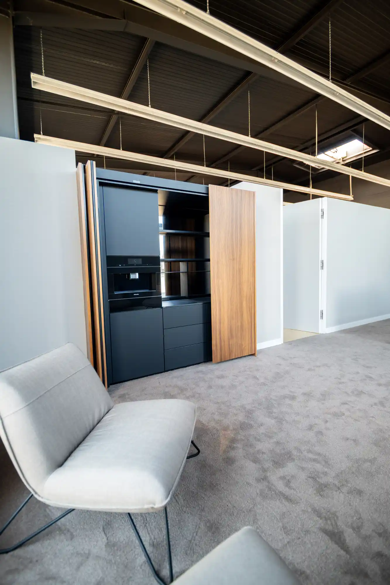 Küche im Schickinger Showroom in Sinzheim – schwarze fronten, holz, sessel
